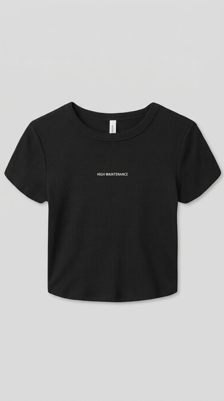 Black fitted baby tee with HIGH MANTENANCE text printed on the chest